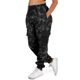 Black cargo pants with geometric pattern worn by a person on a white background
